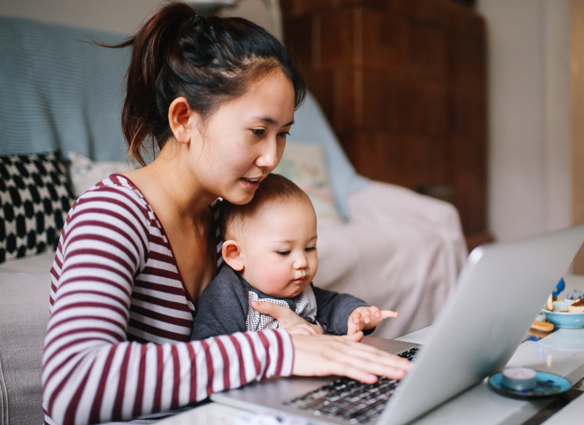 two people talking next to a window.